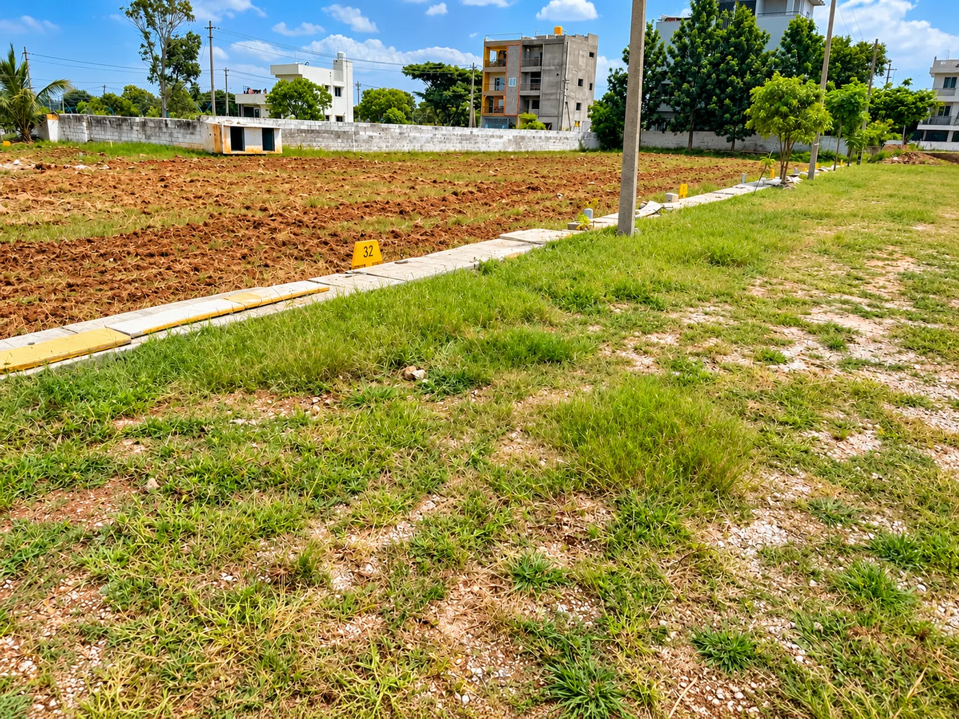 Gathyri Enclave entrance avenue and demarcated residential plot boundaries in Suradhenupura